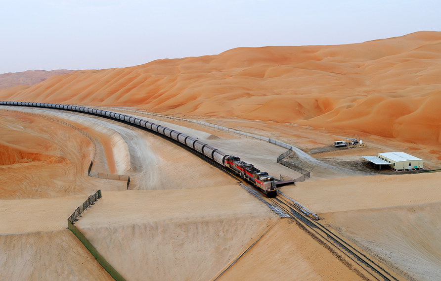 Etihad Rail - train driving between gorgeous orange sand dunes